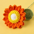 Macro detail of handmade crochet sunflower showing intricate orange petal yarn textures - Orange