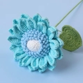 Macro shot of handcrafted sky blue knitted sunflower with detailed crochet texture - Blue