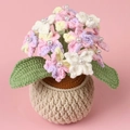Detail of crochet hydrangea potted plant featuring colorful yarn flowers and pearl accents - Gradient Pink