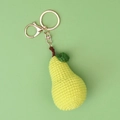 Macro detail of handmade crochet pear keychain with green leaf and gold metal ring - Crocheted Light Green Pear Keychain (lobster Clasp)