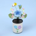 Macro detail of handmade crochet flower pen holder with blue roses and a cute bee - Gradient Blue Rose Style