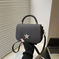 Minimalist black crossbody bag featuring twill fabric and a silver star metallic buckle - Black