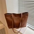 Brown woven PU leather tote bag with large capacity and shoulder straps in modern minimalist style - Tan