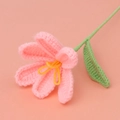 Handmade crochet pink lily flower with yellow stamen and green stem on pink backdrop - Open Tulip Bouquet / Peach Pink