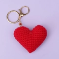 Detailed close-up of handmade red crochet heart keychain with shiny gold lobster clasp - Red