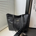 Large black tote bag with floral embossed pattern and golden logo for modern women - Black