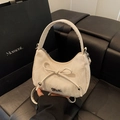 White crescent handbag with elegant bow detail and adjustable shoulder strap for women - White