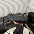 Chic black rectangle baguette bag in matte leather featuring gold fashion lettering - Black