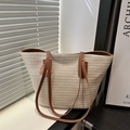 Straw woven tote bag with brown leather straps and pink lace butterfly on a window sill - White