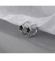 Detail of S925 silver star hoop earrings with black enamel inlay on grey surface - Vintage Star Style