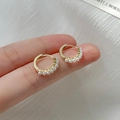 Elegant gold C-shaped hoop earrings featuring small white pearls held by hand - Baroque Pearl Style (EH061)