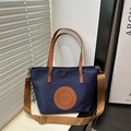 Dark blue nylon tote bag with brown shoulder strap and leather circular logo detail - Small / Dark Blue