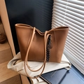 Dark brown leather tote bag with pebble grain texture and fashion slogan detail - Brown