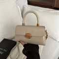 Chic beige oil wax leather crossbody bag with elegant gold hardware and top handle - Khaki