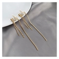 Detail of gold tassel clip-on earrings with U-shaped resin pads on grey silk background - Long Tassel Clip-on