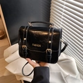 Glossy black patent leather handbag with gold Fashion text and adjustable shoulder strap - Black