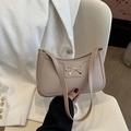 Chic beige hobo shoulder bag with a stylish gold bow accent and sleek leather texture - Khaki