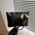 Minimalist black faux leather tote bag with white stitching and floral scarf handle - Black