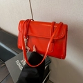 Fashionable bright orange rectangular underarm bag in glossy synthetic leather with charms - Red Bag Style