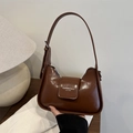 Brown faux leather underarm bag with shoulder strap in a stylish minimalist design - Tan