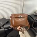 Brown oil wax leather tote bag with metallic clasp closure and vintage styling for commute - Tan