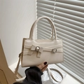 Creamy white PU leather handbag featuring elegant bow detail and silver metal buckles - White