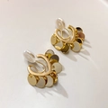 Golden clip-on earrings with heart base and hanging round metal sequins on warm background - Mosquito Coil Ear Clip / Gold