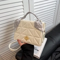 Chic quilted crossbody bag with golden geometric lock and paisley silk scarf handle wrap - White