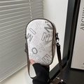 White pebbled leather crossbody bag with black letter print and brown strap accessory - White