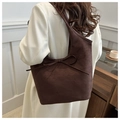 Detail of dark brown suede tote bag featuring elegant bow tie and large capacity design - Brown