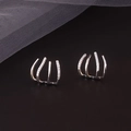 Detailed view of silver four-claw ear studs with parallel rows of micro-pave zircons - Four-Claw Studs - Platinum