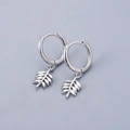 Detailed close-up of S925 sterling silver leaf hoop earrings with fine texture and hallmark - White Gold