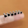 Close-up of mini black heart earrings with silver trim and secure screw-back ball studs - Heart Enamel Stud Earrings