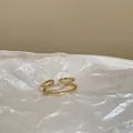 Makro-Detail des goldenen zweilagigen offenen Rings mit funkelndem Zirkonia-Inlay - Einstellbar Offen / Gold