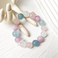 Natural kunzite and rose quartz star beaded bracelet with aquamarine stones on a ceramic hand - Multi-Color Single Strand