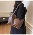 Macro side view of a large brown leather tote bag with side zipper for commuting - Brown