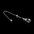 Faceted clear crystal pendulum pendant necklace with silver floral cap on dark surface - White Crystal