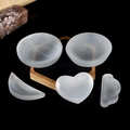 Natural heart and moon shaped selenite crystal bowls for home decor on dark base - Mixed Shapes Bulk