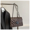 Detail of leopard print chain shoulder bag hanging on a rack beside a grey blazer - Brown