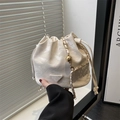 Cream white drawstring bucket bag with gold chain and marble texture finish - White