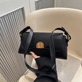Classic black leather baguette bag with a golden arch buckle and wide shoulder strap - Black