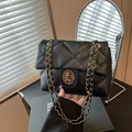 Classic black quilted crossbody bag with golden chain strap and vintage round buckle - Black