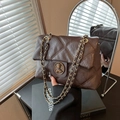 Dark brown quilted chain crossbody bag with vintage gold metal emblem closure - Brown