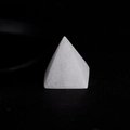 White selenite crystal pyramid massage stone on a minimalist black background - Selenite Small Pyramid