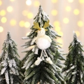 Plush white Christmas reindeer hanging ornament with gold antlers on a snowy pine tree - Elk Style