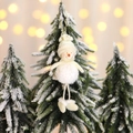 Plush Christmas snowman hanging ornament with knit hat and scarf on a festive tree - Snowman