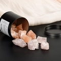 Pink fragrance stone set in a black cylindrical container with orange volcanic rocks - Rose Quartz And Himalayan Salt