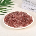 Natural polished red strawberry quartz crystal gravel in a white display ceramic plate - Strawberry Quartz