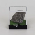 Natural raw quartz specimen in a clear acrylic display case with black base and faux grass - Smoky Quartz