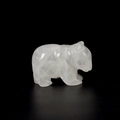 Hand-carved white quartz bear statue with natural stone textures on a black background - White Crystal